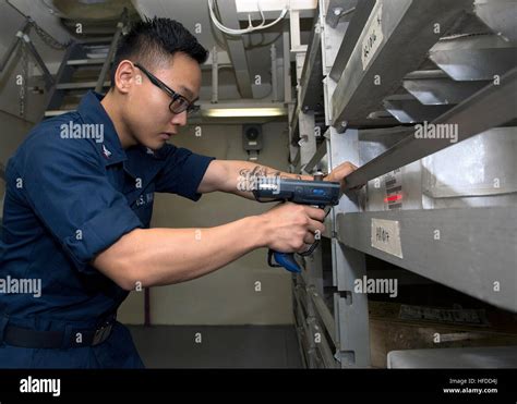 U.S. Navy Logistics Specialist 3rd Class Johnny Bae scans repairable ...
