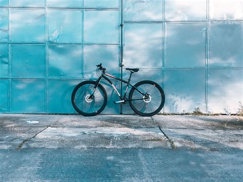 Modern Bicycle Parked Near Shiny Metal Wall · Free Stock Photo