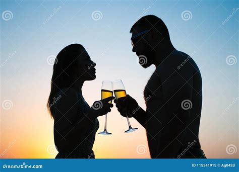 Loving Couple Drinking Wine Or Champagne During Sunset Time Silhouette