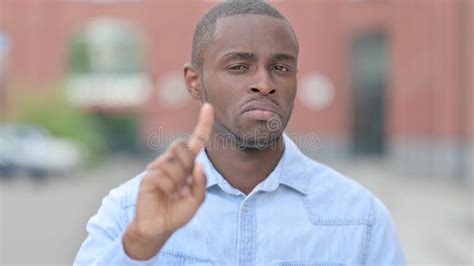 Portrait Of Young African Man Saying No With Hand Gesture Stock Photo