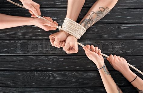 Partial View Of Women Tying Rope Around Stock Image Colourbox