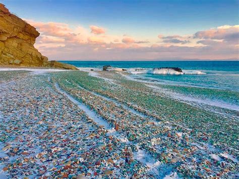 dumped glass on ussuri bay in russia has been shaped into colourful pebbles pebble beach sea