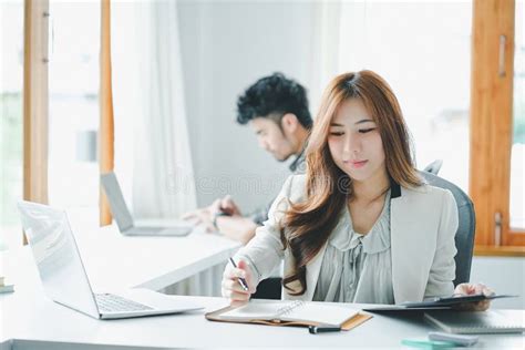 Attractive Asian Business People Working Together At Modern Office