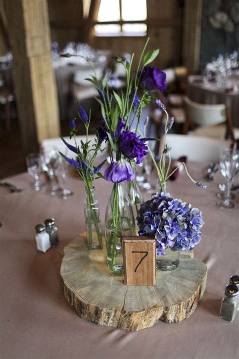 The centerpieces pictured below have been designed by our brides. wild flower centerpiece in random vases on wood slabs, I ...