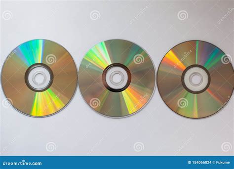 3 Cd Compact Disks With Computer Drivers In A Row On A White Background
