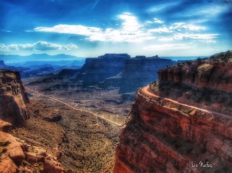 The Sun Shines Brightly In The Distance Over Canyons And Cliffs At