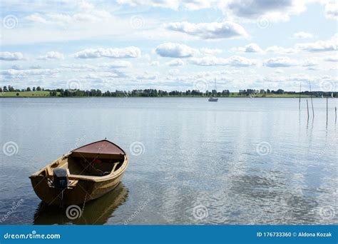 Boat Moored On The Lake Reflection Of The Clouds Stock Photo Image Of