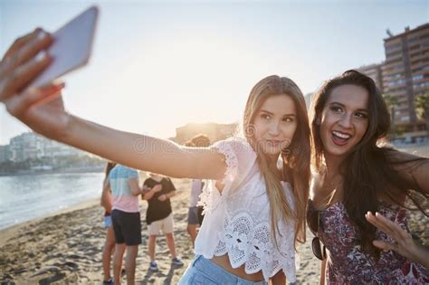 Two Beautiful Women Taking Selfie On Beach Having Fun Stock Photo