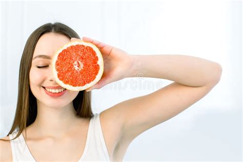 Portrait Of Young Beautiful Woman With Healthy Perfect Skin Holds Piece