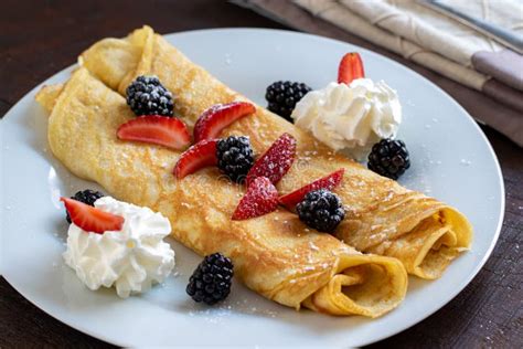 Sweet Thin Pancakes With Whipped Cream And Red Fruits Stock Image
