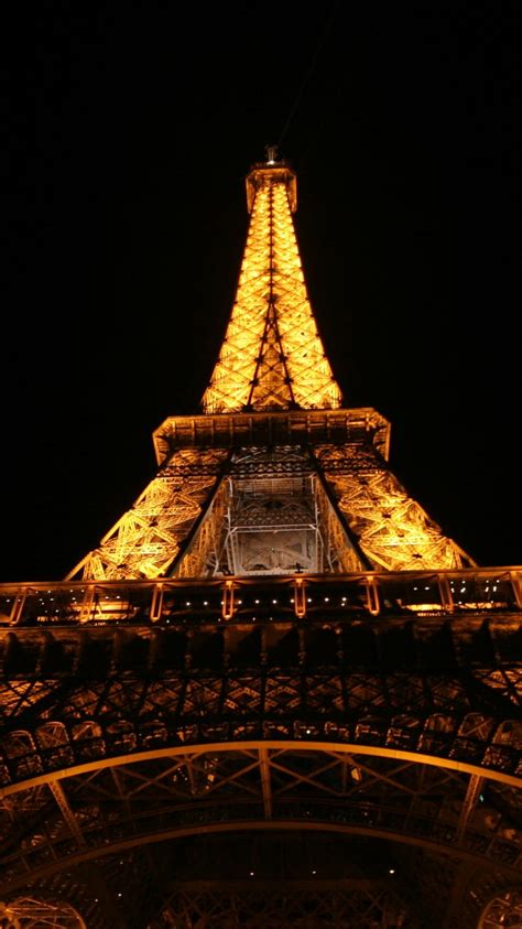 Upward View Of Yellow Lighting Paris Eiffel Tower With Black Sky
