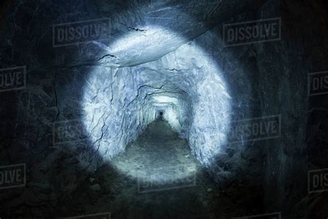 Photograph Of Tunnel In Cave Illuminated By Flashlight Inspiration
