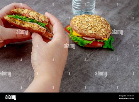 Woman Eating Whole Grain Sandwiches With Ham Cheese Tomatoes And Lettuce Healthy Food Stock