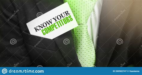 Businessman Putting A Card With Text Know Your Competitors In The