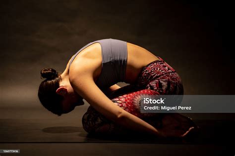 Young Female Yogi Assumes Embryo Pose Stock Photo Download Image Now