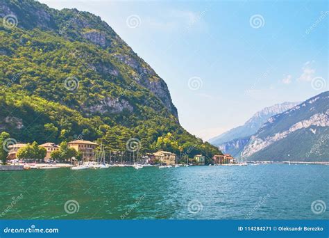 Steep Alpine Banks Of Beautiful Lake Como With Parked Boats And Yachts