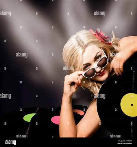 Artistic Pinup Portrait Of A Female Music Turntable Dj Holding Vinyl Record Under Disco Stage