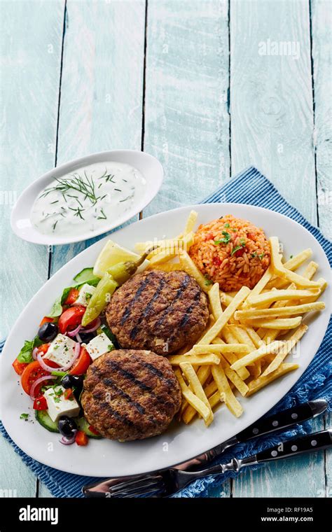 Traditional Greek Cuisine With Bifteki Or Spicy Meat Balls Tomato