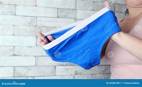 Woman Holding Blue Female Panties In Her Hands Knitted Underwear Concept Of Comfortable