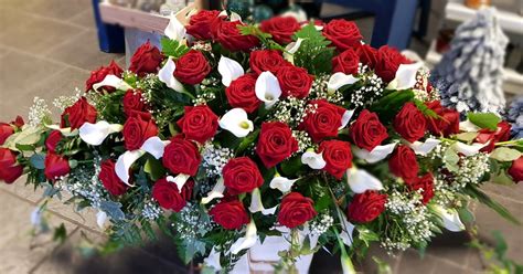 This Epic Red Rose And White Calla Lily Casket Spray Really Shows The