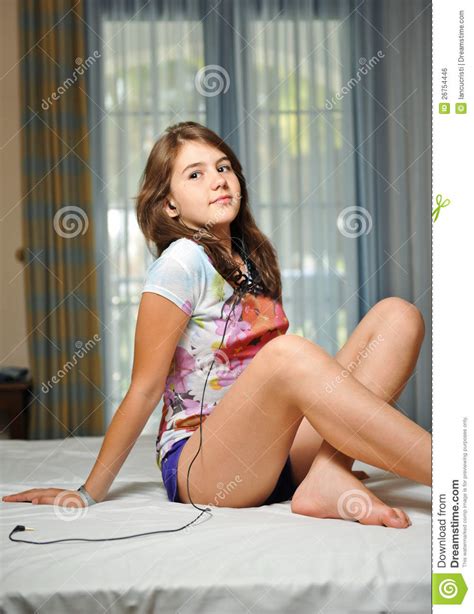 Teen Girl Laying On Her Bed Listening Music Stock