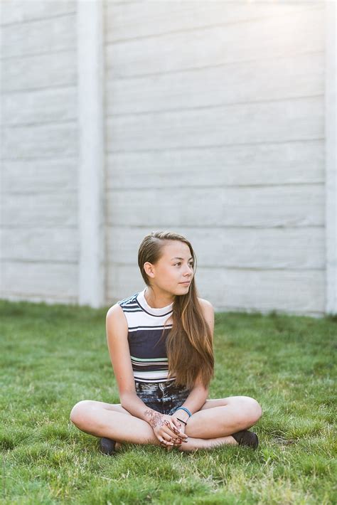 Early Teen Girl Sitting On Lawn By Stocksy Contributor Ronnie Comeau Stocksy