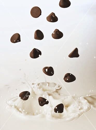 Chocolate Chips Falling Into Milk Buy Images Stockfood