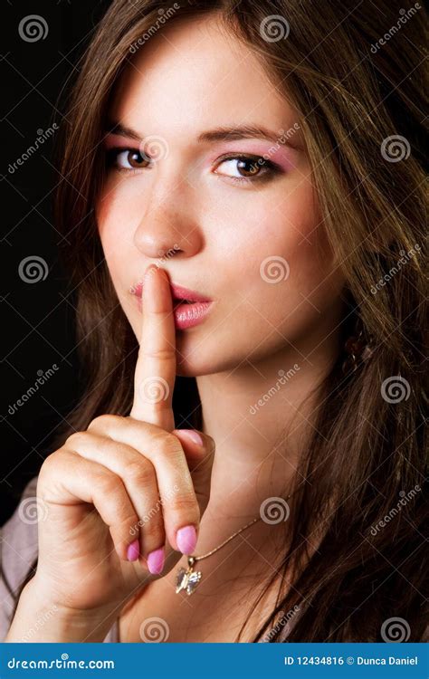 woman with finger on lips asking for silence or secrecy stock image 207840775