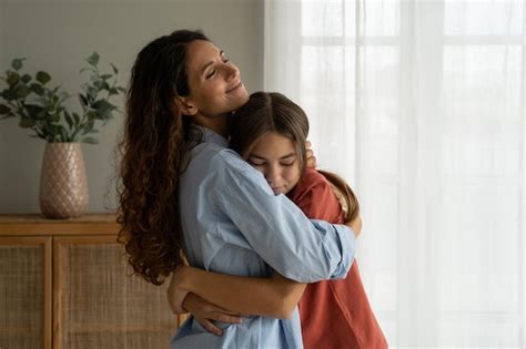 Premium Photo Young Loving Mother Hugging Teenage Daughter At Home Mom Cuddling Supporting