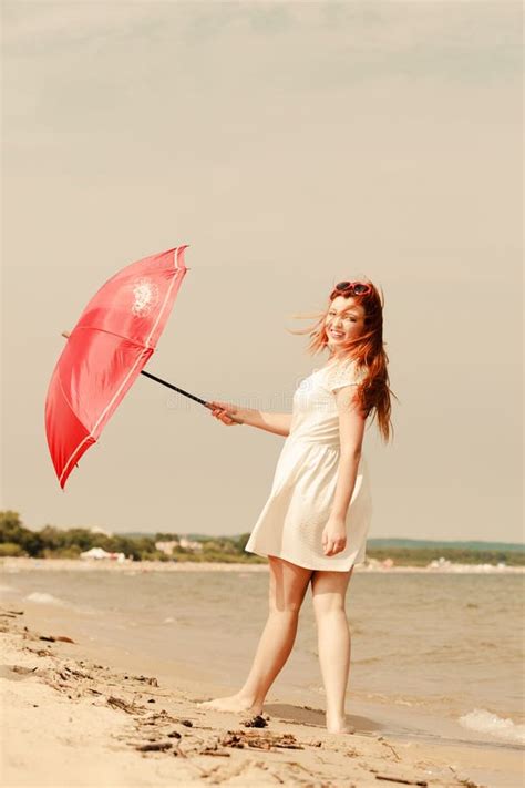 Redhead Woman Walking On Beach Holding Umbrella Stock Image Image Of