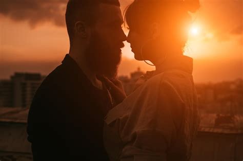 Premium Photo Sensual Romantic Couple Kissing On Rooftop At Sunset