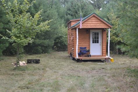 Cedar and cypress wood makes up the structure, with hardwood floors throughout the home. Tiny Log Cabin on Wheels by Rolling Cabins