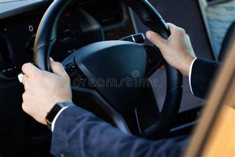 Close Up Of Man Hand On Vehicle Steering Wheel As He Is Driving Male