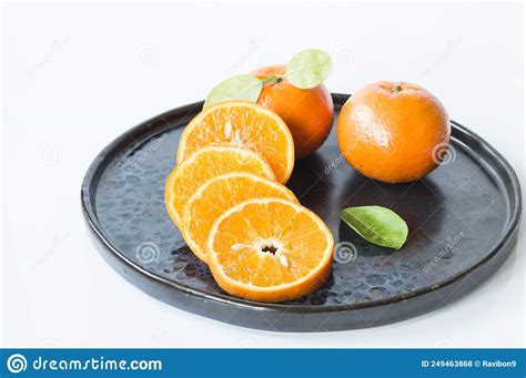 Mandarin Oranges With Oily Yellow Skin And Overlapping Slices Stock
