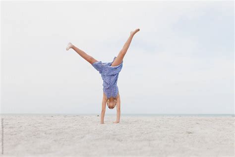 Girl Doing A Cartwheel On The Beach By Stocksy Contributor Amanda