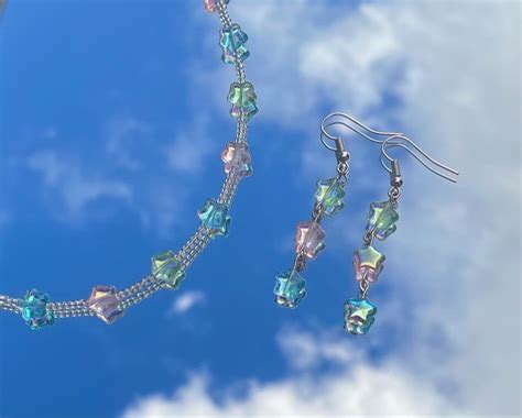 A Necklace And Earring Set With Swaro Cut Crystal Beads On A Blue Sky