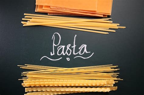 Premium Photo Close Up Of Raw Pastas With Text On Black Background