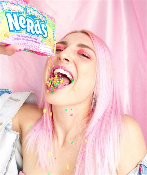 woman-with-pink-hair-pouring-nerds-candy-in-her-mouth-2156656 | Sharon