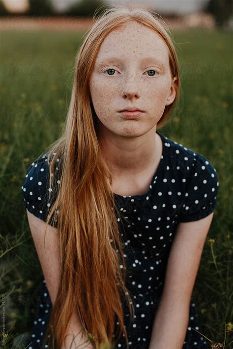 Young Girl Sitting In Field Del Colaborador De Stocksy Sidney