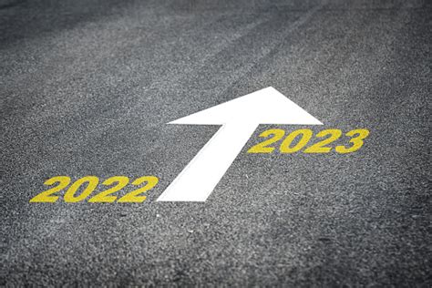 Year 2022 To 2023 And White Arrow Marking On Road Surface Stock Photo