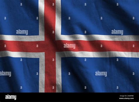 Iceland Flag With Big Folds Waving Close Up Under The Studio Light