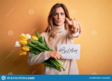 Beautiful Brunette Woman Holding Best Mom Message And Tulips Celebrating Mothers Day Pointing