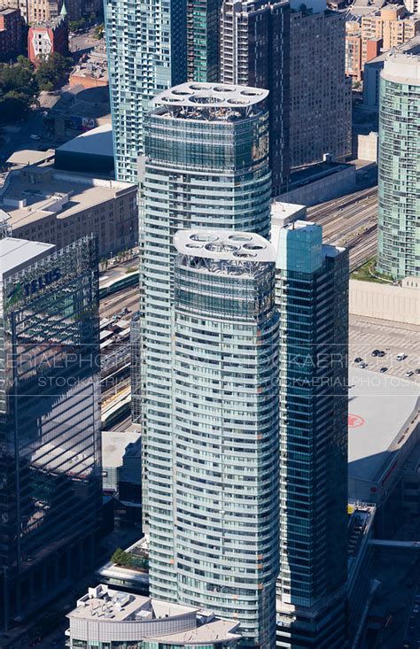 Lounge chairs, a swing glider and picnic tables are located on our carpeted sundeck, along with a barbeque grill and firepit nearby. Aerial Photo | ICE Condos, Toronto