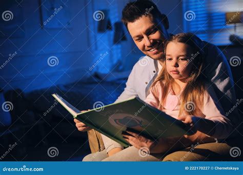 father reading bedtime story to daughter at home stock image image of bonding caucasian