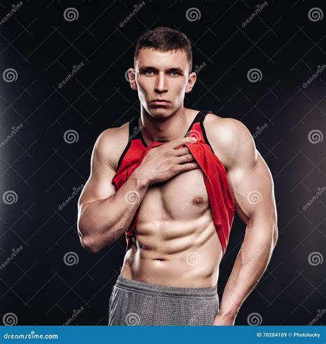 Muscular Fitness Man Showing Sixpack Muscles Without Fat Over Black