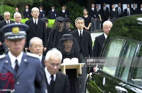 Emperor Akihito And Empress Michiko Follow A Casket Car Carrying The