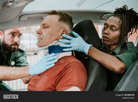 Paramedic Placing A Cervical Collar To An Injured Man From Car Accident