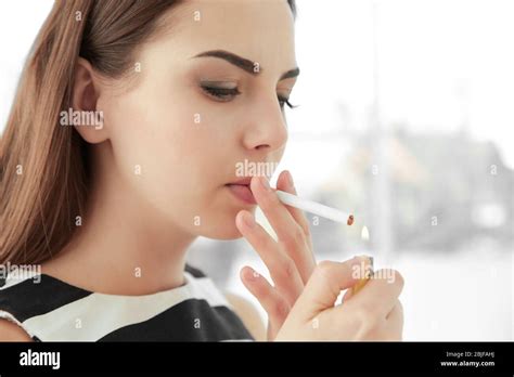 Young Woman Lighting Cigarette At Home Stock Photo Alamy