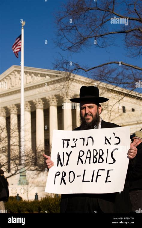 new york rabbi stands in front of the us supreme court holding a sign in support of pro life