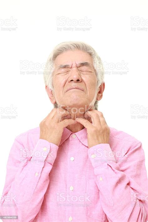 Senior Japanese Man Scratching His Neck Stock Photo Download Image